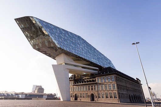 Old building with modern construction with glass façade above