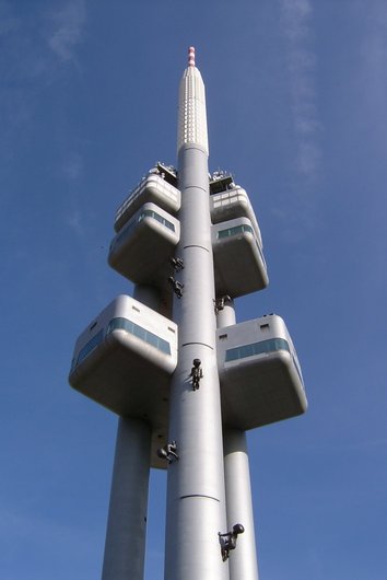 Television tower from below with figures apparently climbing the tower