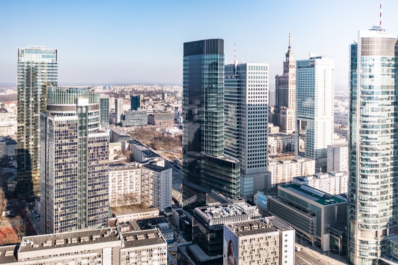 An urban landscape with numerous skyscrapers and modern buildings under a clear sky.