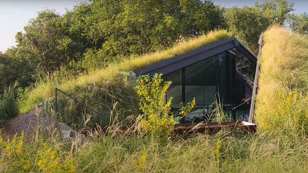 Hill with meadow in which a house is hidden