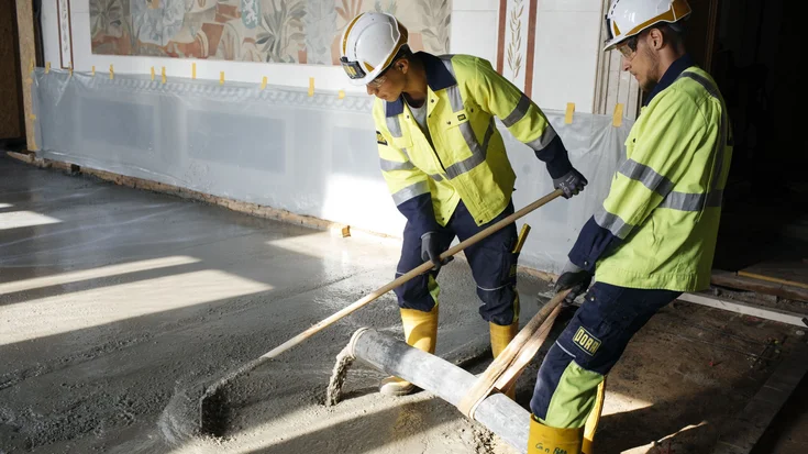 Zwei junge Bauarbeiter sanieren einen Boden im ParlamentsgebÀude in Wien