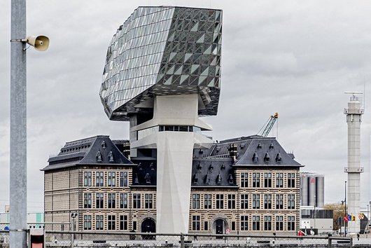 Old building with modern construction with glass façade above