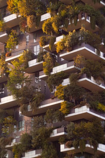 The façade of the Bosco Verticale in Milan, a high-rise building with planted balconies. The vertical gardens combine architecture and nature.