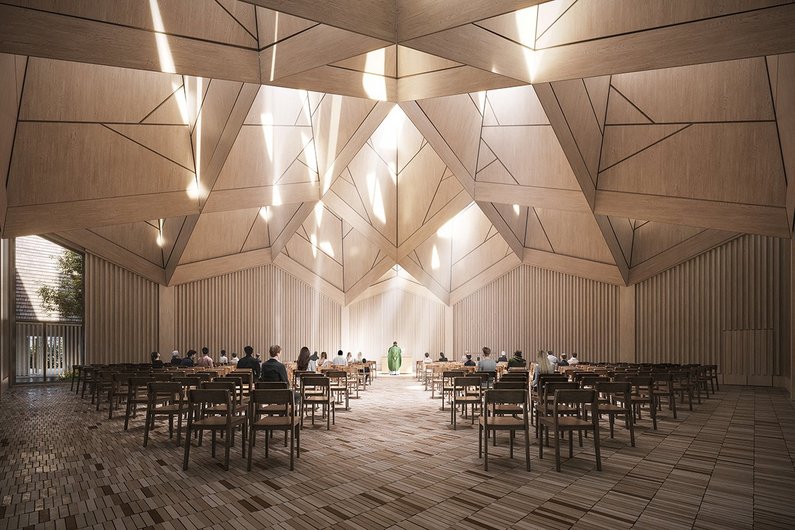 A modern church interior with a wood-panelled, geometric ceiling and numerous rows of seats.