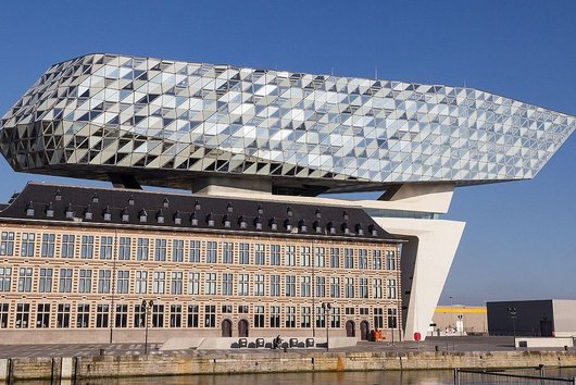 Old building with modern construction with glass façade above